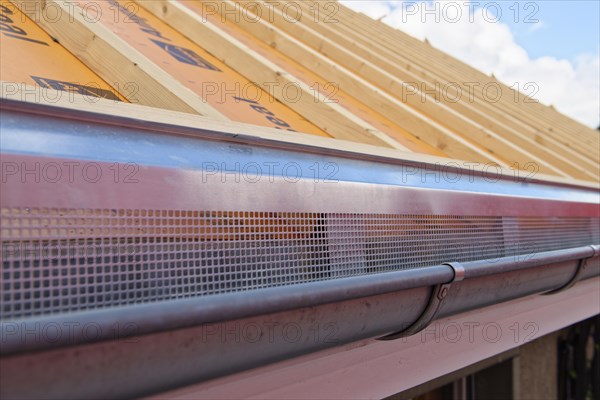 Ventilation sheets at the gutter on a roof for an in-roof photovoltaic system.