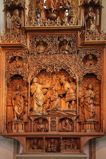Late Gothic high altar with wood carving with saint by Christoph von Urach 1520 in the St. Cyriakus town church