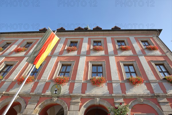 Town hall with German national flag and town coat of arms
