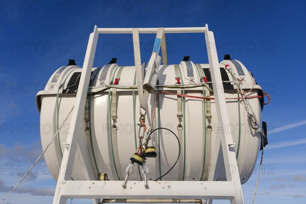 Container with life raft on a ship