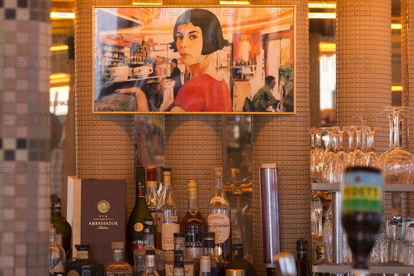 Poster above the bar in the Cafe des Deux Moulins