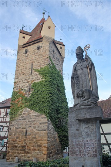 Historic Fehnturm built 13th century and sculpture Saint at the well with bible quotation from John 4-14