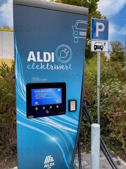 Charging point of supermarket chain Aldi for e-car in front of supermarket next to it traffic sign Parking for e-cars can be charged