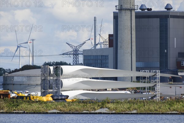 Rotor blades for wind turbines lie in the industrial harbour