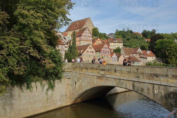 Stone arch bridge over the Kocher to the river island Unterwoehrd and cityscape with new building