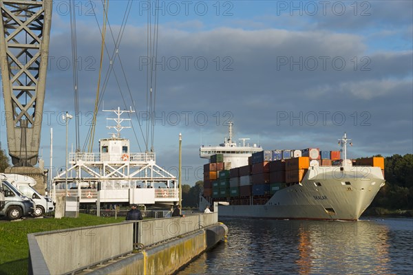 Suspended ferry and ship under the Rendsburg railway high bridge over the Kiel Canal