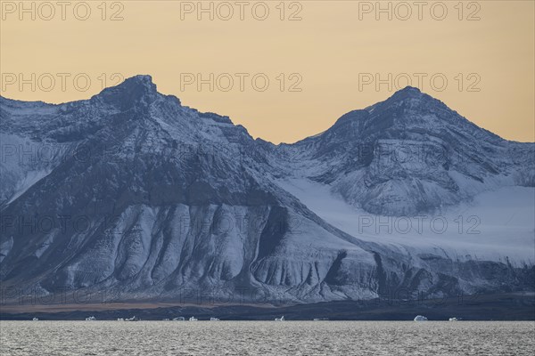 Icebergs in front of mountain range