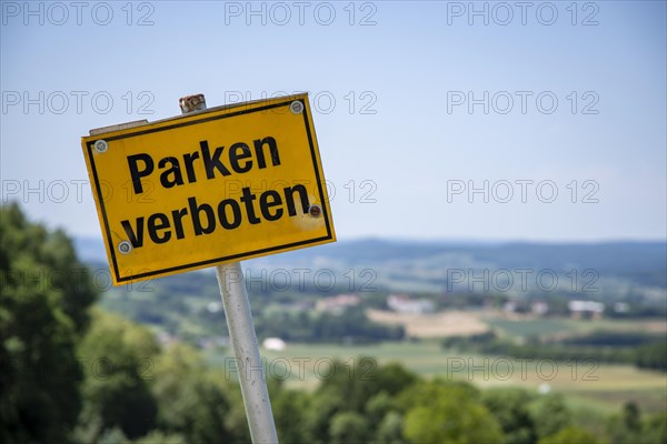 Yellow sign Parking Prohibited in front of hilly