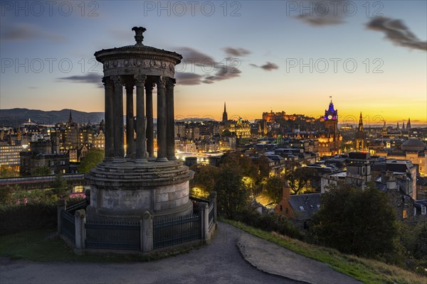 View from Calton Hill with the Dugald Stewart Monument over the historic Old Town with Edinburgh Castle at night