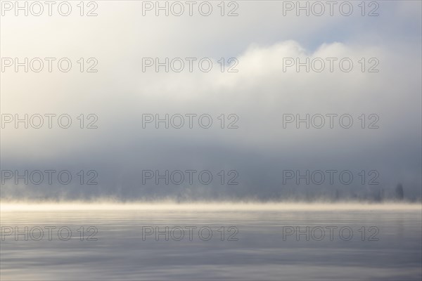 Fog over Lake Constance on an autumn morning with boats