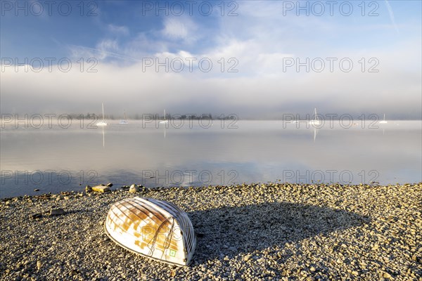 Fog over Lake Constance on an autumn morning with boats