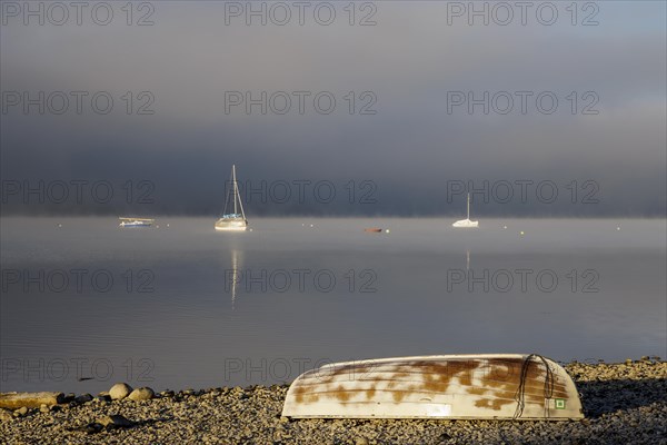 Fog over Lake Constance on an autumn morning with boats