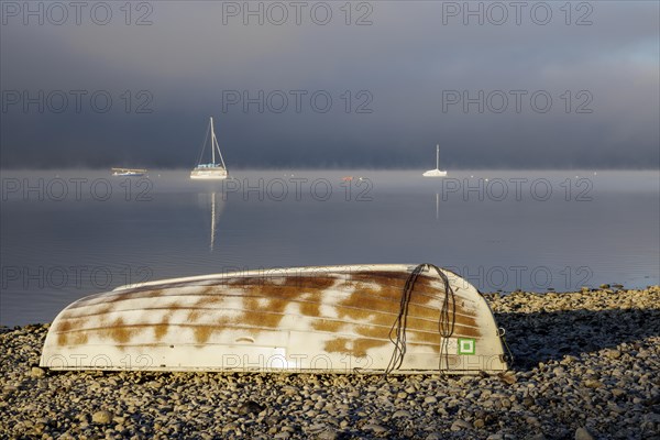 Fog over Lake Constance on an autumn morning with boats