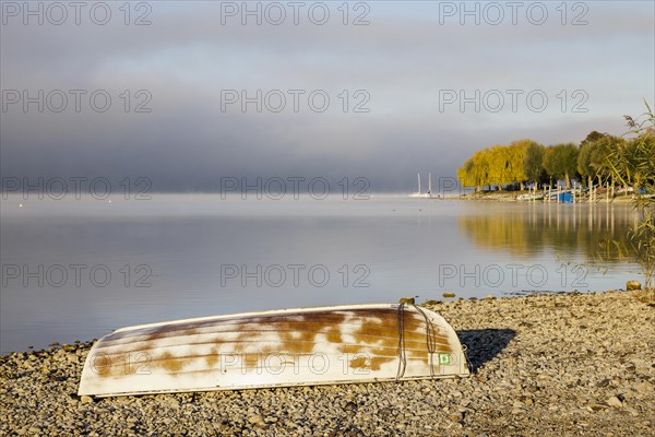 Fog over Lake Constance on an autumn morning with boats