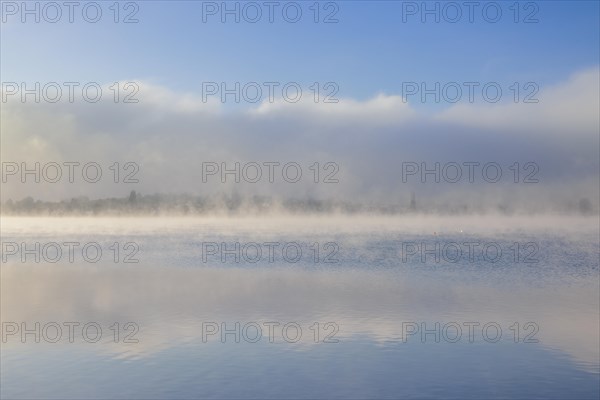 Fog over Lake Constance on an autumn morning with boats