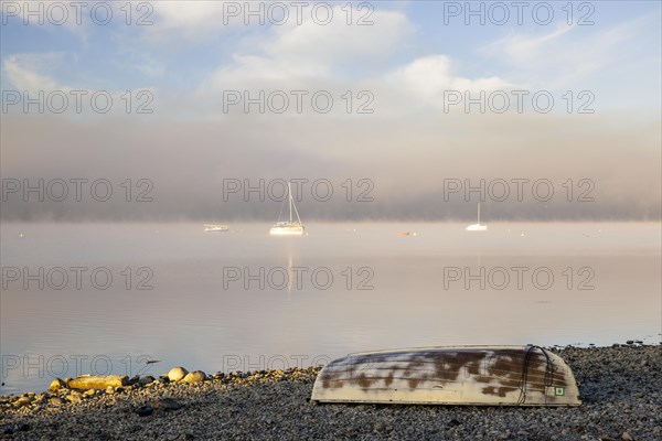 Fog over Lake Constance on an autumn morning with boats