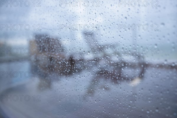 Raindrops on a window pane looking out onto the terrace