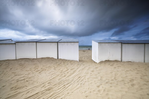 Evening mood with cloudy sky and rain on the beach and in the dunes of De Panne