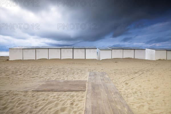 Evening mood with cloudy sky and rain on the beach and in the dunes of De Panne