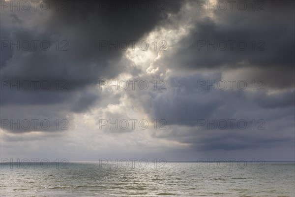 Evening mood with cloudy sky and rain on the beach and in the dunes of De Panne