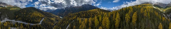 Colourful autumn landscape with a view of the Swiss National Park and the Lai dad Ova Spin reservoir