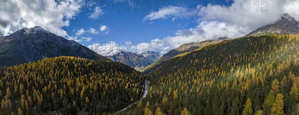 Colourful autumn landscape with a view of the Swiss National Park and the Lai dad Ova Spin reservoir