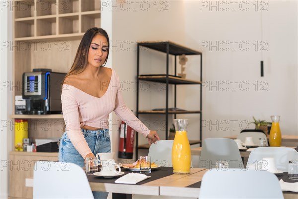 Casual business woman having breakfast in a luxury hotel with a buffet