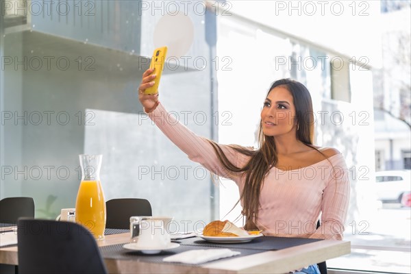Casual beauty Businesswoman taking a selfie while having breakfast in a luxury hotel in the morning