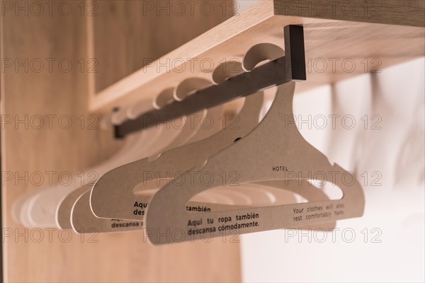 Photo with no people and close-up of a set of hangers in the hotel closet