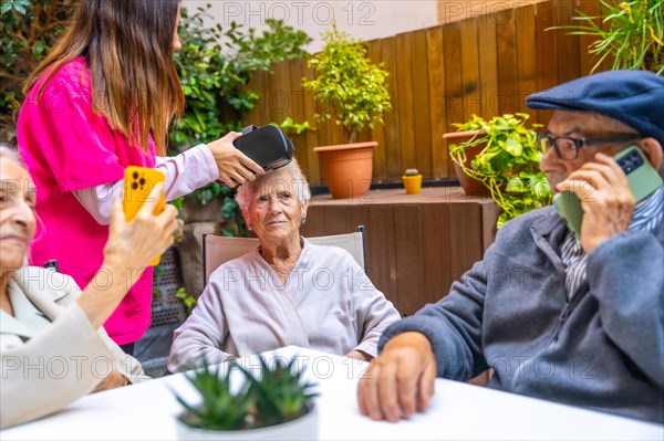 Three senior people ready to use virtual reality goggles in a geriatric