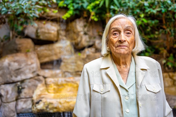 Portrait of an elder woman in the garden of a nursing home