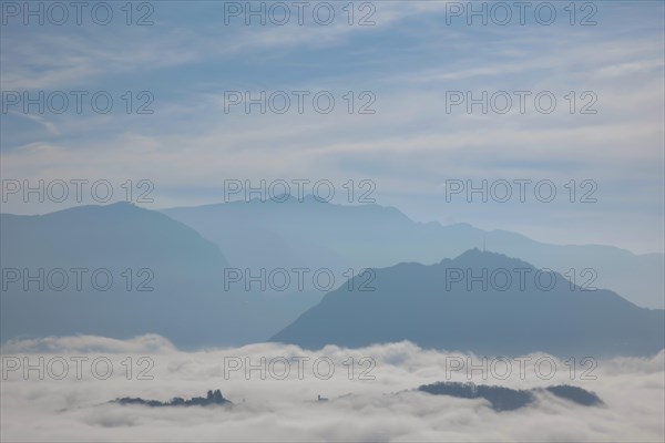 Mountain Peak Above Cloudscape and a Church in a Sunny Day in Lugano