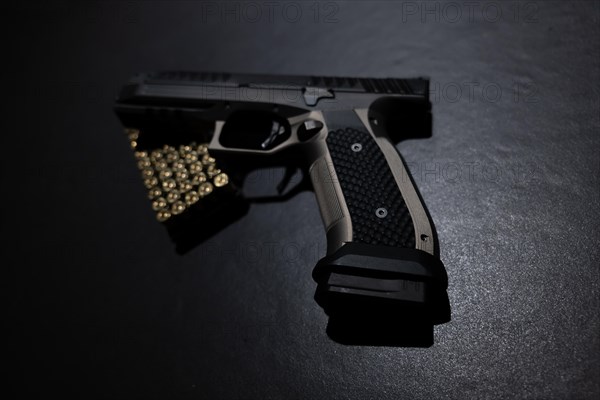 Modern Elegant Handgun and Bullet on Grey Background in Switzerland