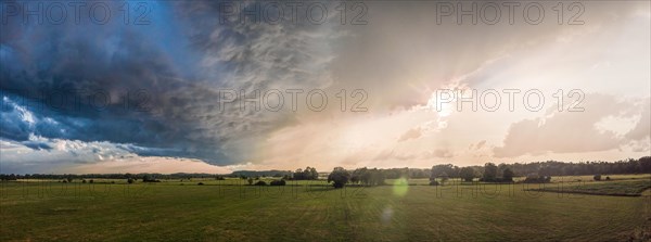 Summer landscape with majestic clouds after thunderstorm