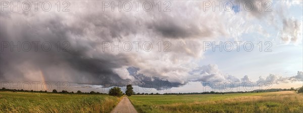 Summer landscape with majestic clouds after thunderstorm