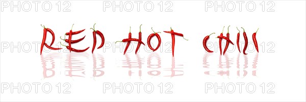 Red chilli peppers arranged to spell out RED HOT CHILI . The chillies are against a white background