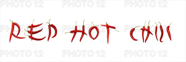 Red chilli peppers arranged to spell out RED HOT CHILI . The chillies are against a white background