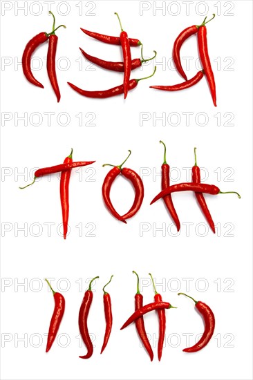 Red chilli peppers arranged to spell out RED HOT CHILI . The chillies are against a white background