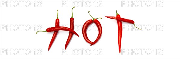 Red chilli peppers arranged to spell out RED HOT CHILI . The chillies are against a white background