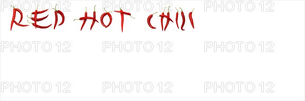 Red chilli peppers arranged to spell out RED HOT CHILI . The chillies are against a white background