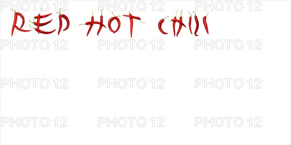 Red chilli peppers arranged to spell out RED HOT CHILI . The chillies are against a white background