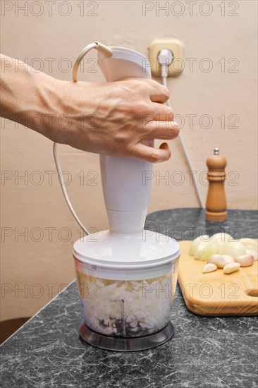Grinding onions and garlic in a blender