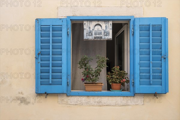 Window with blue shutters