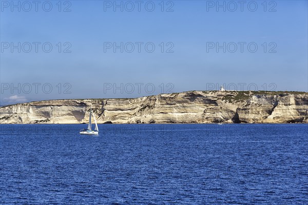 Sailboat in front of white chalk cliffs
