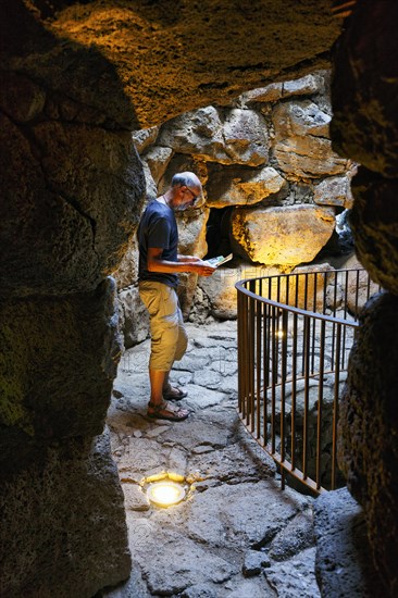 Tourist exploring Nuraghe Santu Antine