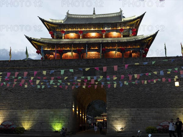 Old Chinese city gate with illuminated roofs