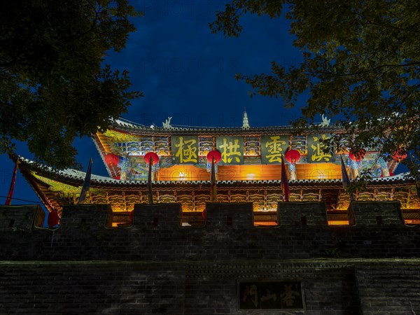 Old Chinese city gate with illuminated roofs