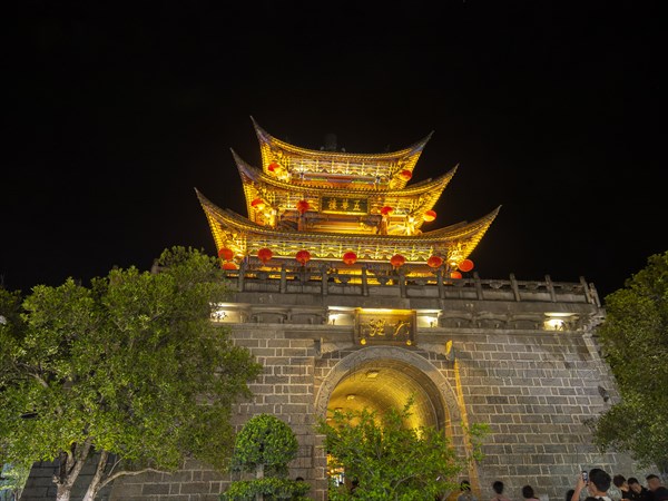 Old Chinese city gate with illuminated roofs