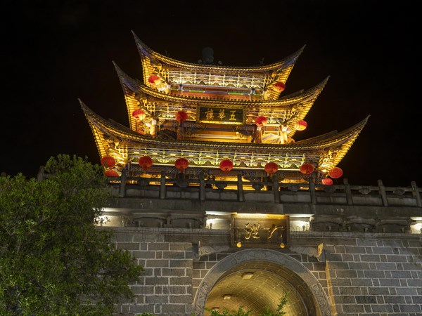 Old Chinese city gate with illuminated roofs