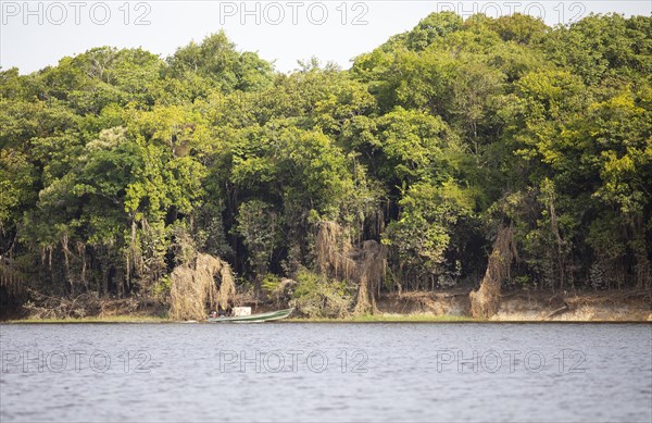 Boat and riverside landscape on the Rio Amazonas at low water level